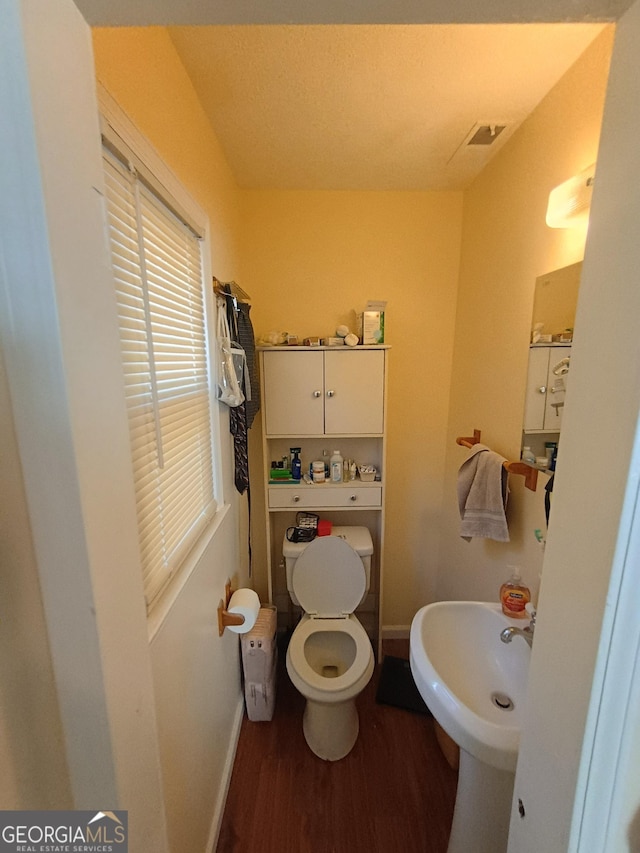 bathroom featuring toilet and hardwood / wood-style flooring