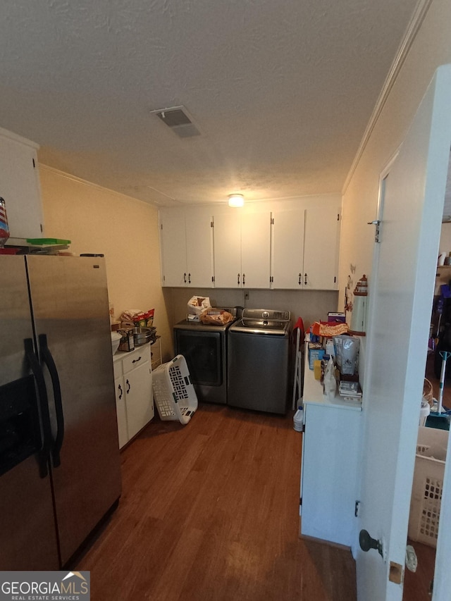 kitchen with hardwood / wood-style floors, stainless steel refrigerator with ice dispenser, separate washer and dryer, a textured ceiling, and white cabinetry