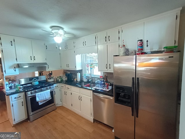 kitchen with white cabinetry, sink, ceiling fan, light hardwood / wood-style flooring, and appliances with stainless steel finishes