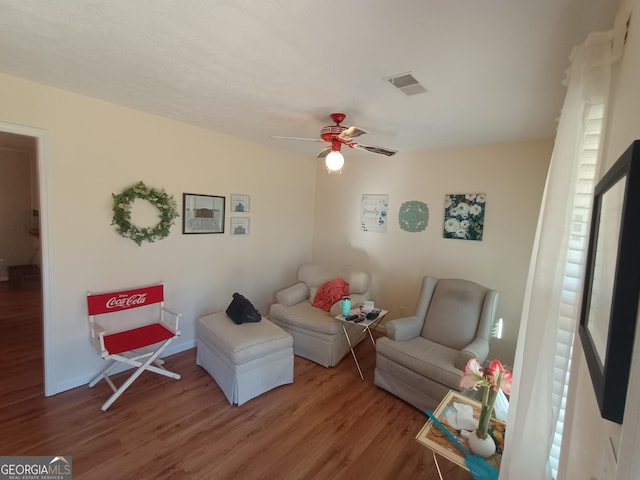 living room with hardwood / wood-style flooring and ceiling fan