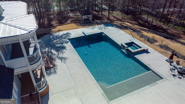 view of swimming pool with an in ground hot tub and a patio