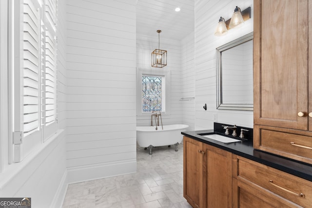 bathroom with a bathing tub, vanity, and wood walls