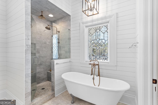 bathroom featuring wood walls and independent shower and bath