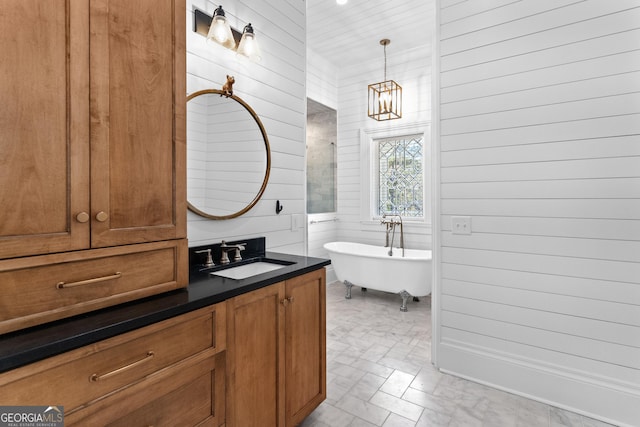 bathroom featuring vanity, a tub to relax in, an inviting chandelier, and wooden walls