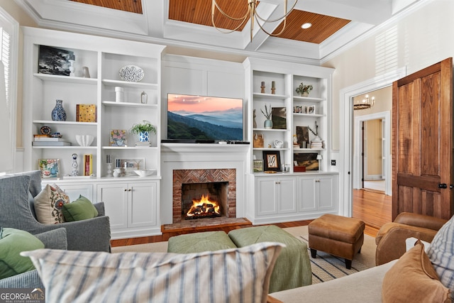 living room with coffered ceiling, built in shelves, beam ceiling, light hardwood / wood-style flooring, and a chandelier