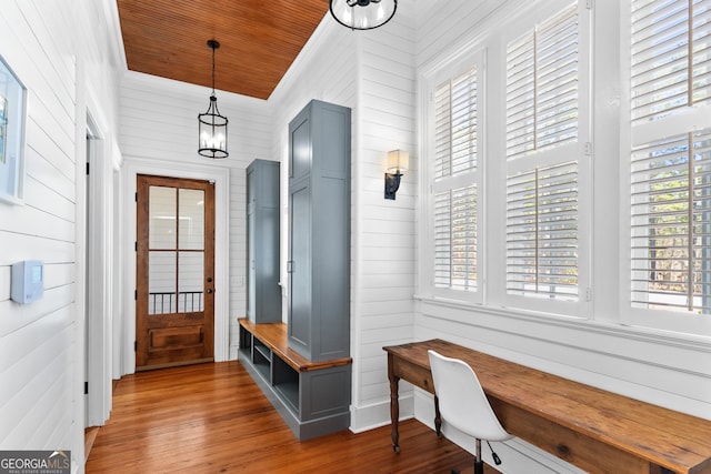 mudroom with wooden walls, a healthy amount of sunlight, and wood ceiling