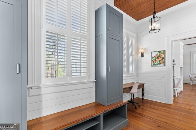 mudroom with wooden walls, hardwood / wood-style floors, wooden ceiling, and a notable chandelier