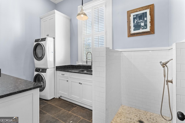 clothes washing area with stacked washer / dryer and sink