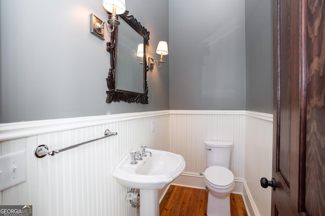 bathroom with hardwood / wood-style floors and toilet