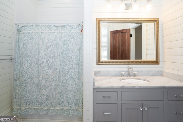 bathroom with wood walls and vanity