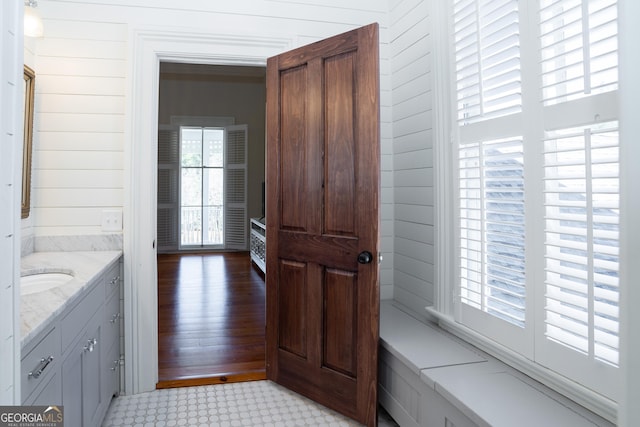 interior space with wood walls and vanity