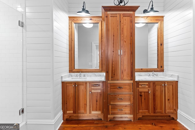 bathroom featuring vanity and wood walls