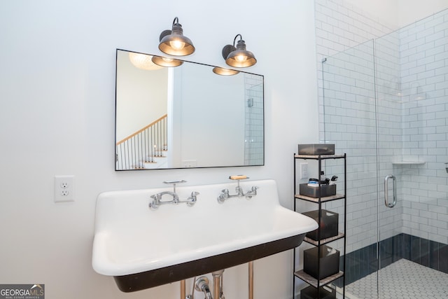 bathroom with walk in shower and sink