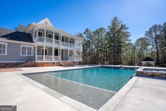 view of swimming pool with a gazebo and a patio