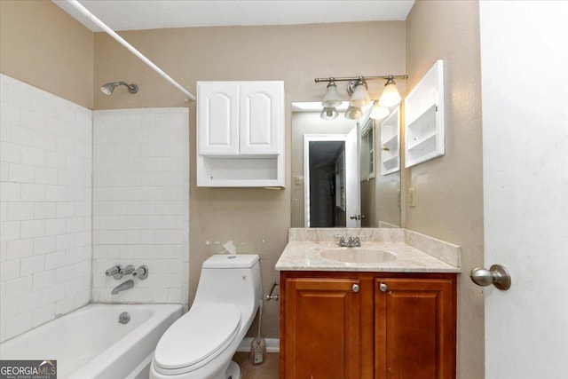 full bathroom featuring vanity, toilet, and tiled shower / bath