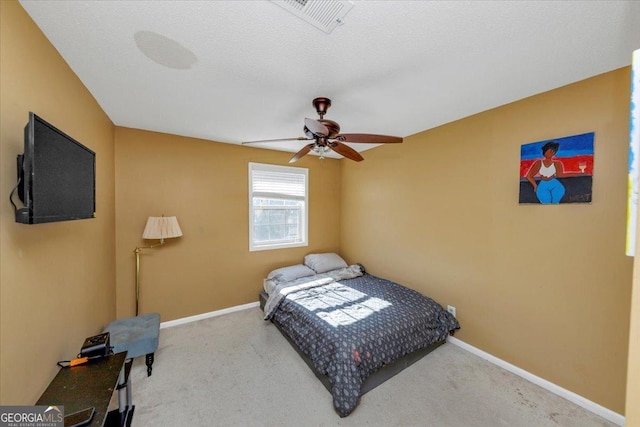 bedroom featuring carpet flooring, ceiling fan, and a textured ceiling