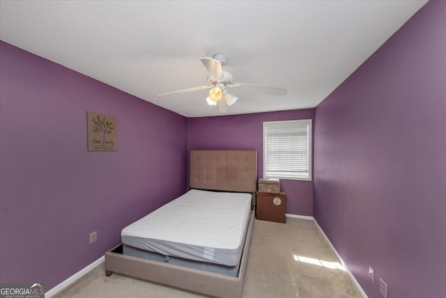 bedroom with ceiling fan and light carpet