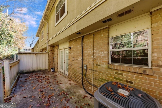 view of home's exterior with french doors and central AC