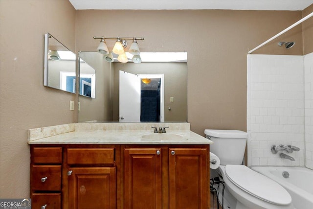 full bathroom featuring vanity, toilet, and tiled shower / bath