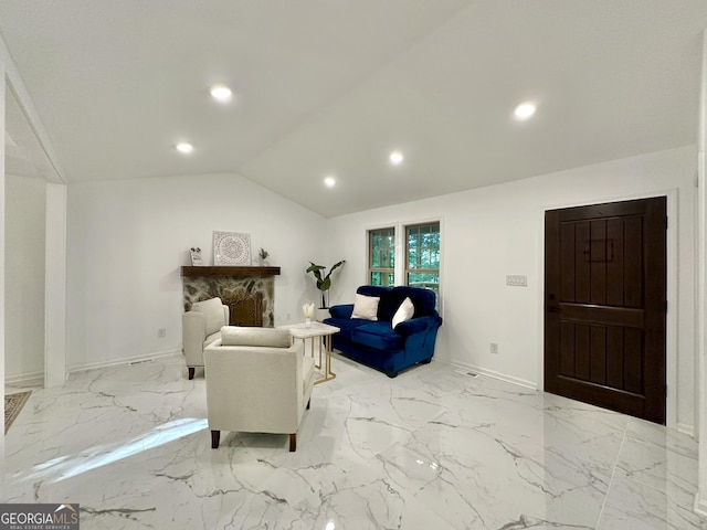 living room with a fireplace and lofted ceiling