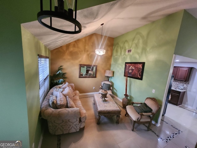 living room with a chandelier and vaulted ceiling