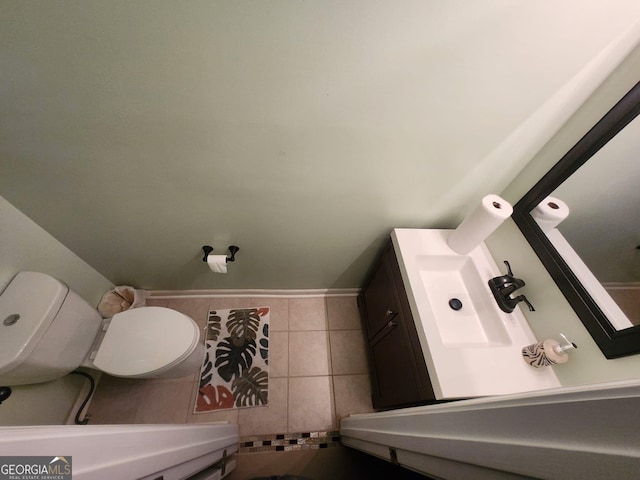 bathroom featuring tile patterned flooring, vanity, and toilet