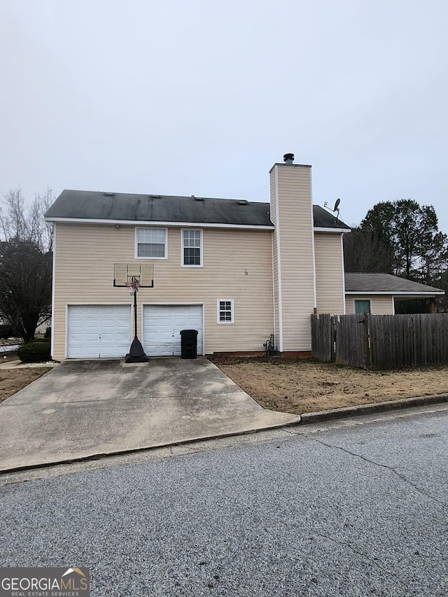 rear view of property with a garage