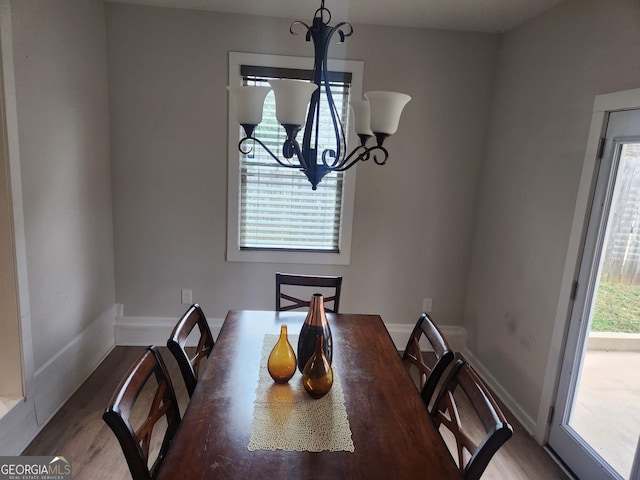 dining room with a chandelier and hardwood / wood-style flooring