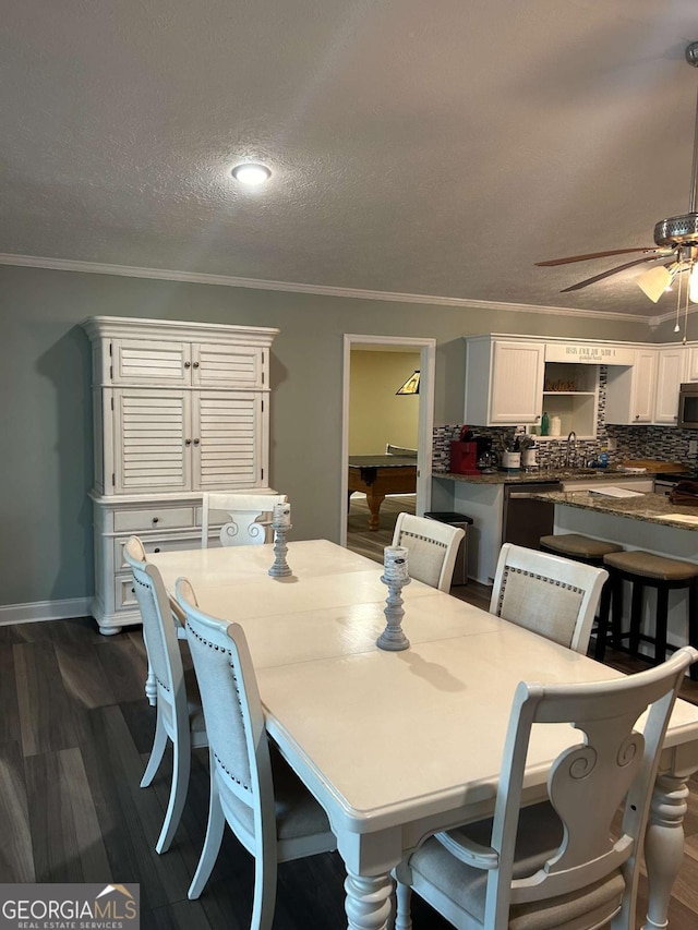 dining space featuring a textured ceiling, ceiling fan, crown molding, sink, and billiards