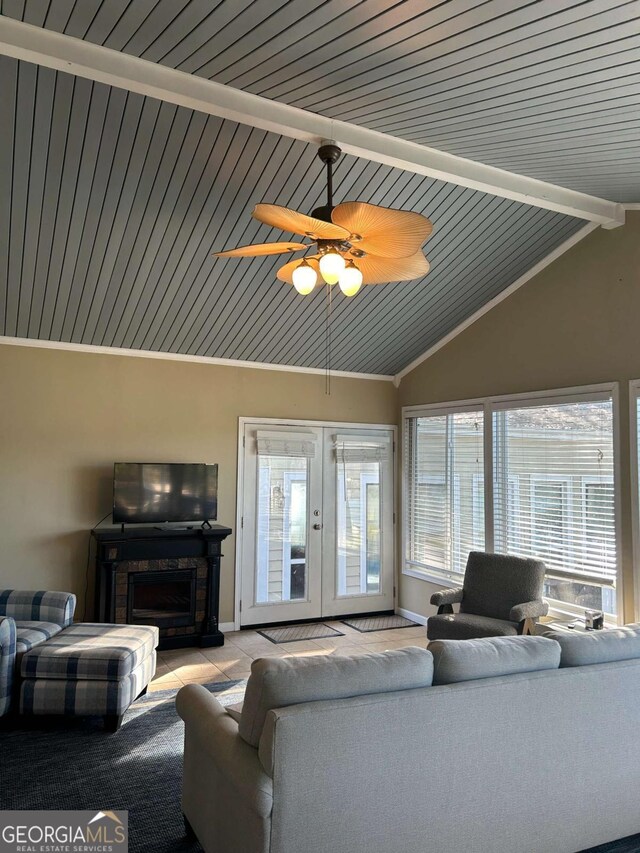 living room with french doors, vaulted ceiling with beams, and ceiling fan