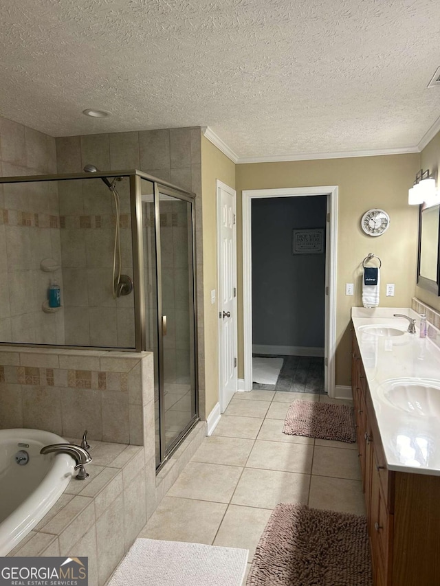 bathroom with tile patterned flooring, vanity, ornamental molding, and shower with separate bathtub