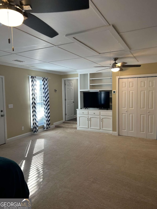 unfurnished living room with light carpet and built in shelves