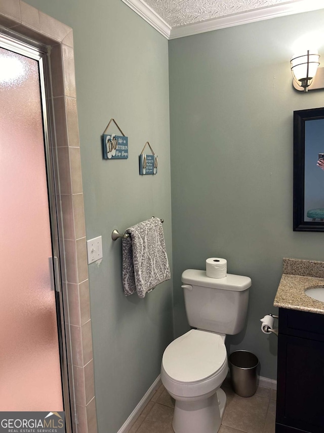 bathroom featuring tile patterned flooring, vanity, a textured ceiling, and ornamental molding