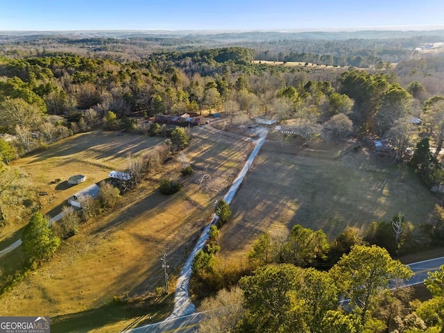 drone / aerial view featuring a forest view