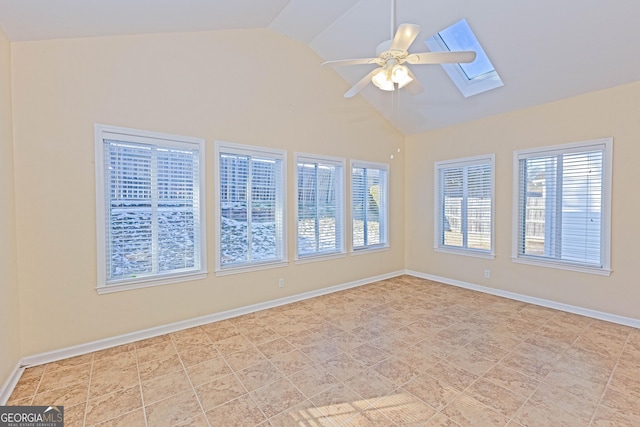 spare room featuring lofted ceiling with skylight, ceiling fan, and light tile patterned floors