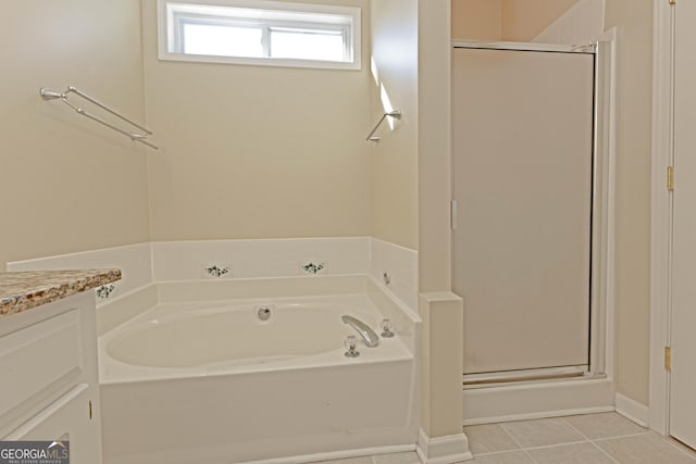 bathroom with tile patterned floors, vanity, and shower with separate bathtub