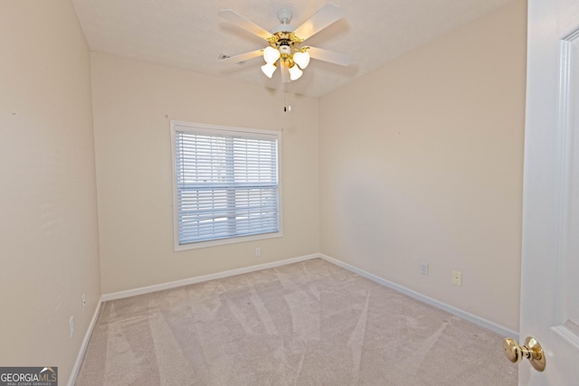 empty room featuring ceiling fan and light carpet