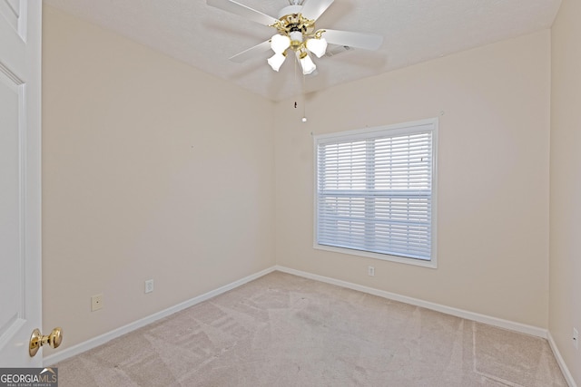 carpeted empty room featuring ceiling fan