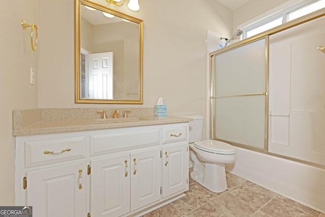 full bathroom with vanity, toilet, and combined bath / shower with glass door