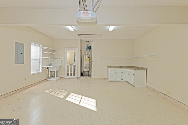 garage with electric panel, sink, a garage door opener, and water heater