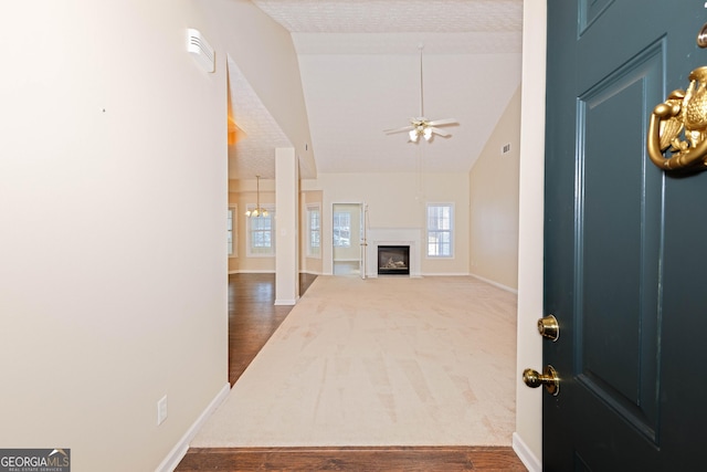 entrance foyer with ceiling fan, dark wood-type flooring, and lofted ceiling