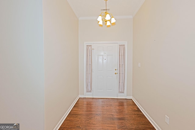 doorway to outside with ornamental molding, dark wood-type flooring, and a chandelier