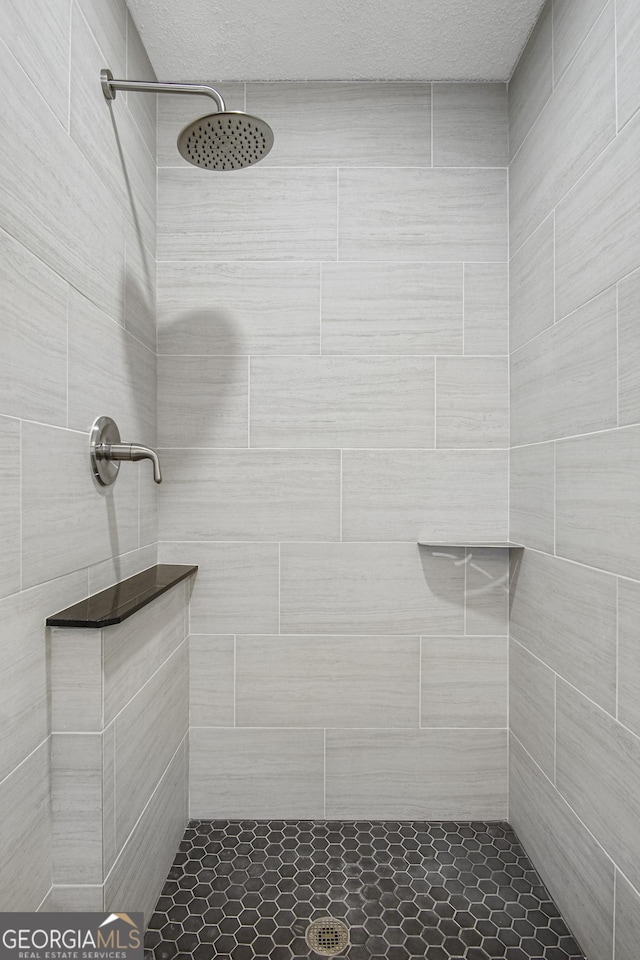 bathroom with a tile shower