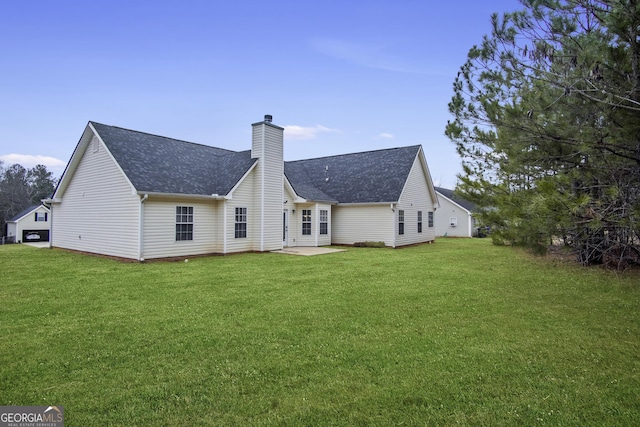 rear view of property with a lawn and a patio