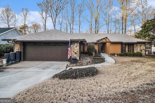 ranch-style home featuring a garage and a front lawn