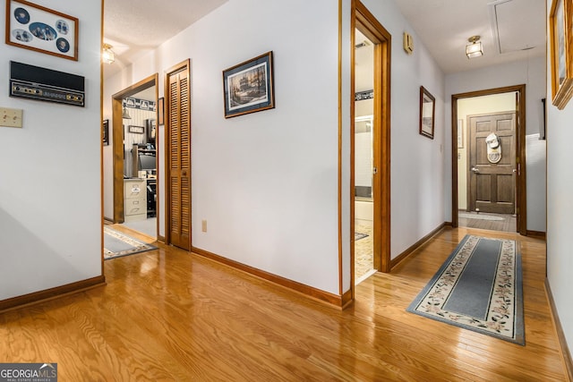 hallway with light hardwood / wood-style floors