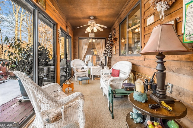 sunroom / solarium with ceiling fan, a healthy amount of sunlight, and wood ceiling