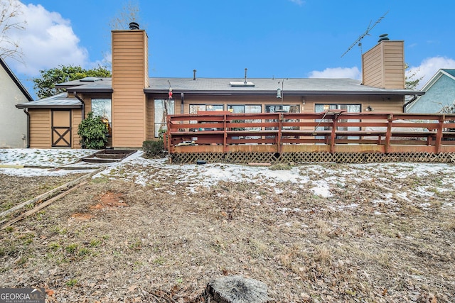 snow covered property featuring a deck