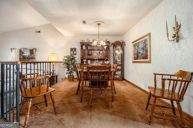 carpeted dining area with an inviting chandelier and lofted ceiling