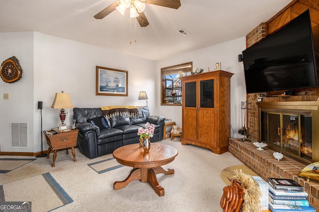 living room featuring ceiling fan, light carpet, and a fireplace